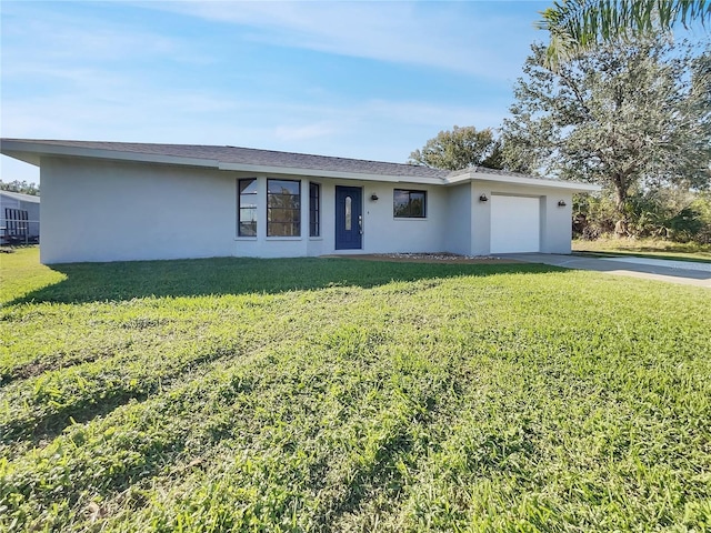 single story home featuring driveway, an attached garage, a front yard, and stucco siding