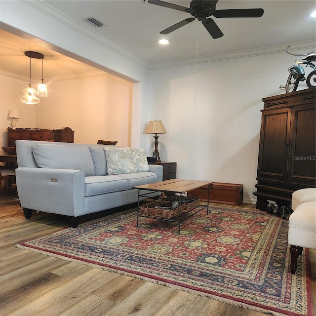 living room with visible vents, ceiling fan, ornamental molding, recessed lighting, and wood finished floors