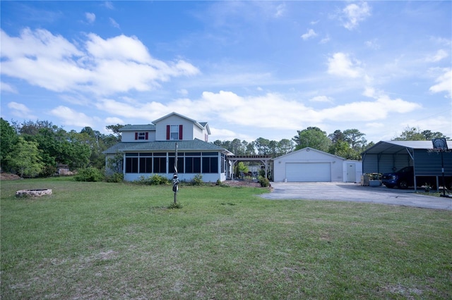 view of front of house featuring driveway, a garage, a sunroom, an outdoor structure, and a front yard