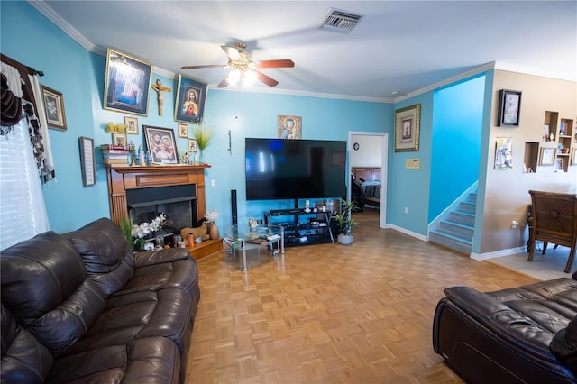 living room with a fireplace with raised hearth, visible vents, baseboards, stairs, and ornamental molding