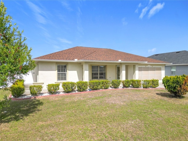 ranch-style house with a shingled roof, a front yard, and stucco siding