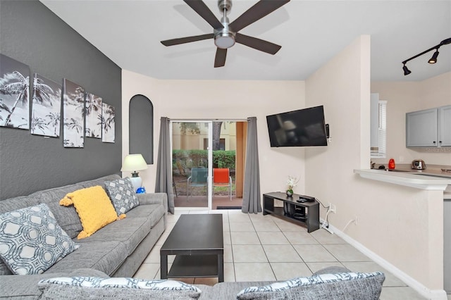 living room with a ceiling fan, light tile patterned flooring, and baseboards