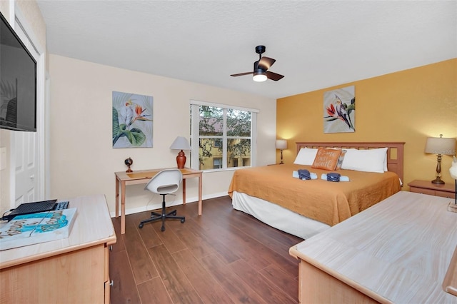 bedroom featuring dark wood-style floors, baseboards, and a ceiling fan