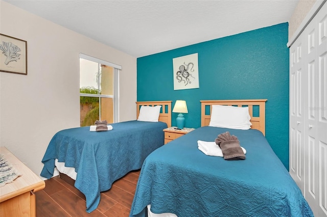 bedroom with wood finish floors and a closet