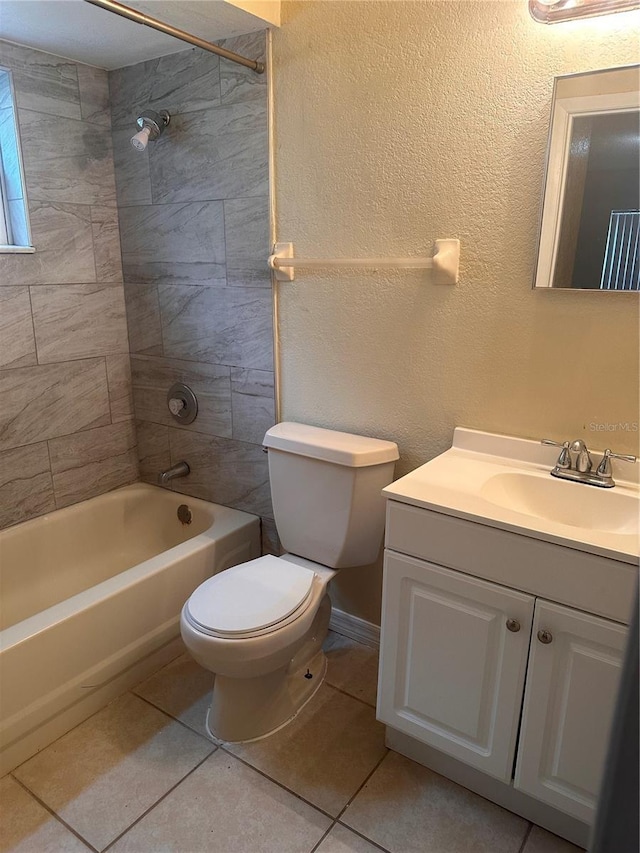 bathroom featuring tile patterned floors, toilet, shower / bathtub combination, vanity, and a textured wall