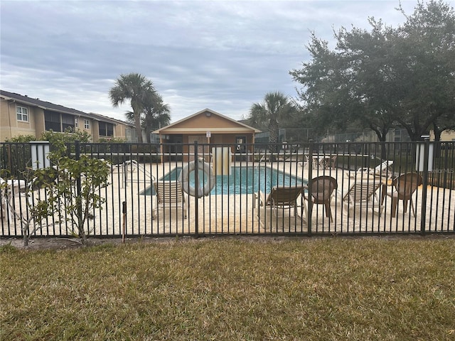 pool with a patio and fence