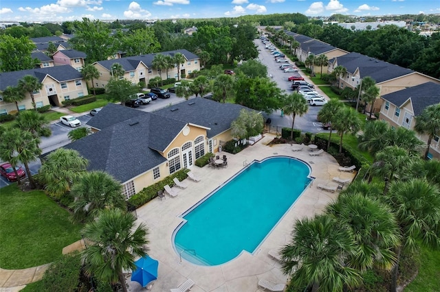 pool with a residential view and a patio area