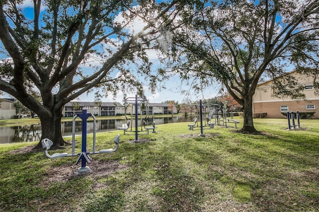 view of yard with a residential view, a water view, and playground community