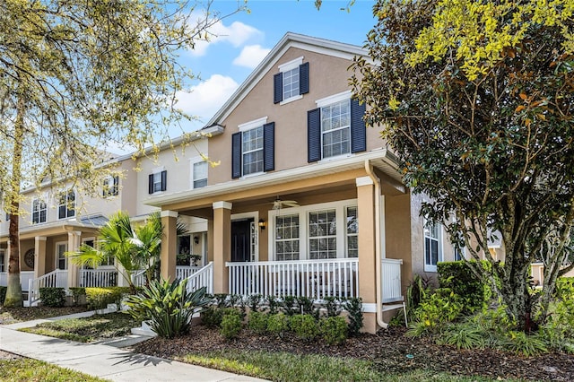 traditional home with covered porch and stucco siding