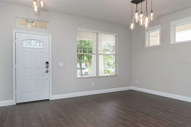 entryway with dark wood-style floors and baseboards