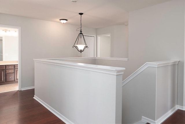 hall with dark wood-style floors and baseboards