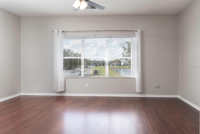 unfurnished room featuring ceiling fan, baseboards, and wood finished floors