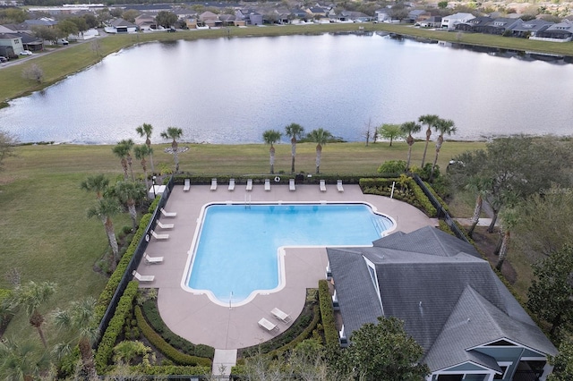 pool with a water view and a yard