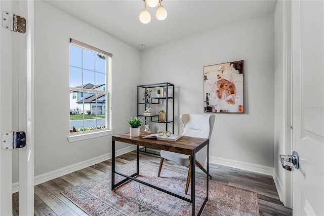 home office featuring wood finished floors and baseboards