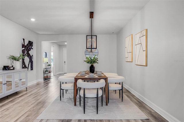 dining area with recessed lighting, baseboards, and light wood-style floors