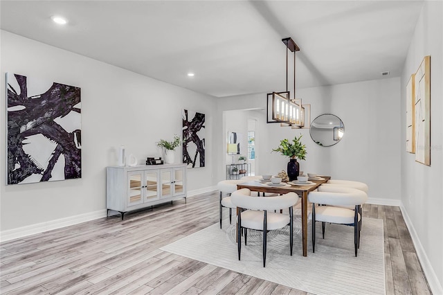 dining area with recessed lighting, baseboards, and wood finished floors