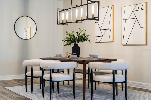 dining space with wood finished floors and baseboards