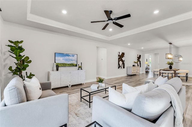 living area with recessed lighting, light wood-type flooring, and crown molding