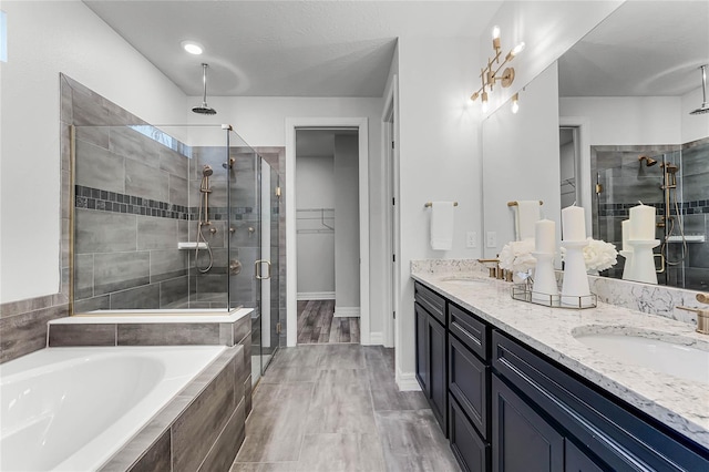 bathroom featuring a shower stall, a bath, and a sink