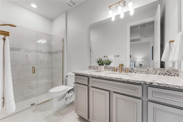 bathroom featuring visible vents, toilet, a stall shower, and vanity