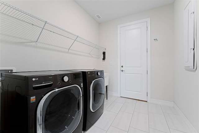 laundry area with visible vents, baseboards, light tile patterned floors, laundry area, and washer and dryer