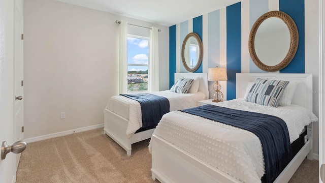 bedroom featuring light carpet and baseboards