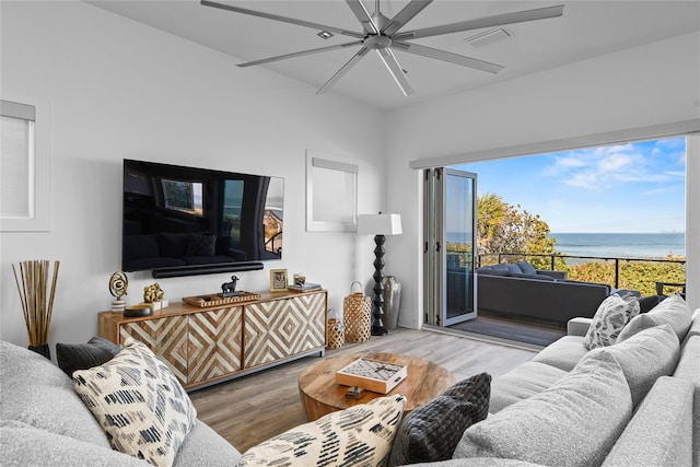 living room featuring ceiling fan, wood finished floors, and visible vents