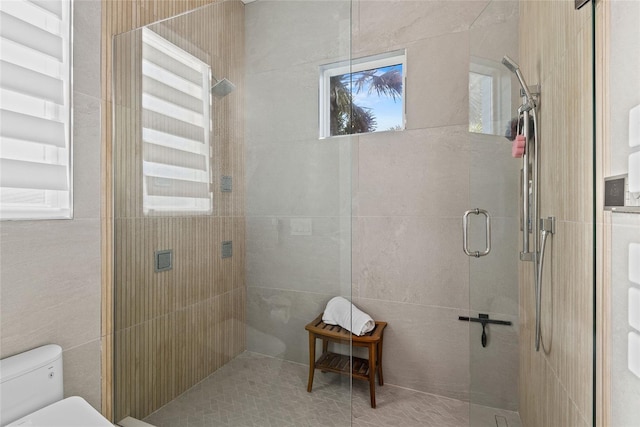 full bath with a stall shower and toilet