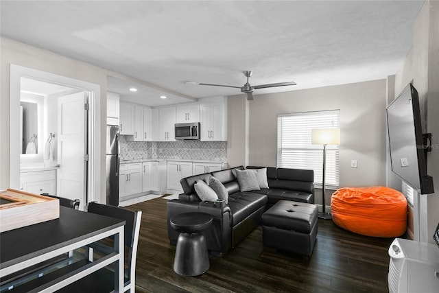 living room with ceiling fan, dark wood-style flooring, and recessed lighting