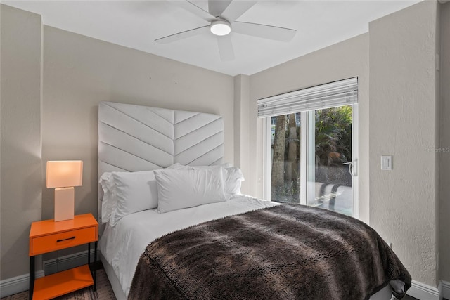 bedroom with access to outside, ceiling fan, and baseboards