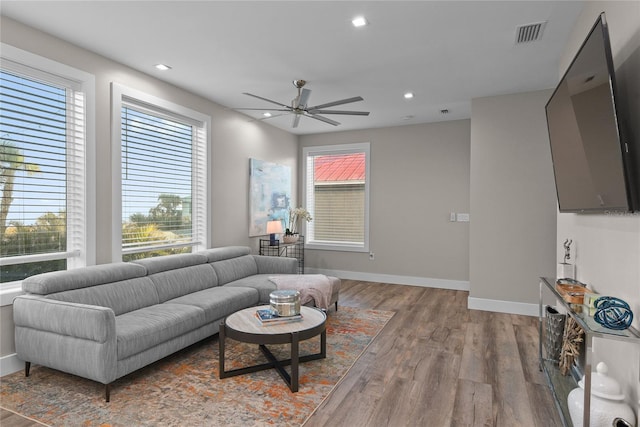 living room featuring baseboards, visible vents, ceiling fan, wood finished floors, and recessed lighting