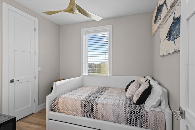 bedroom with a ceiling fan and wood finished floors