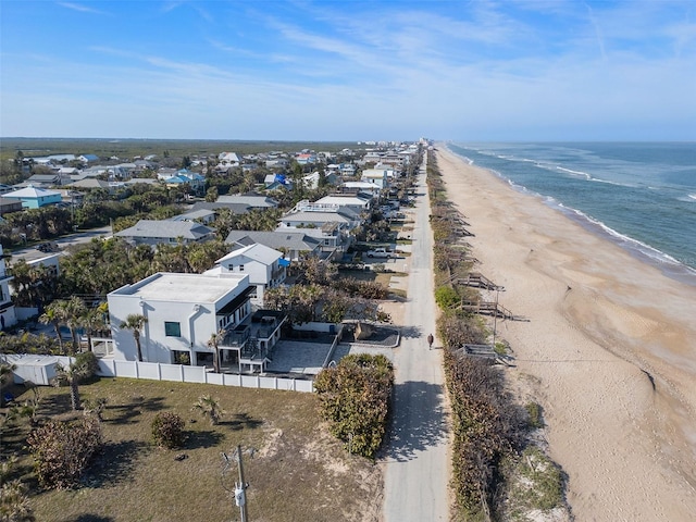 bird's eye view with a water view and a beach view