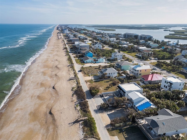 drone / aerial view with a water view and a view of the beach