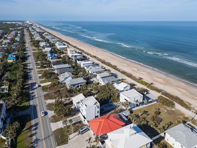 birds eye view of property with a water view and a view of the beach