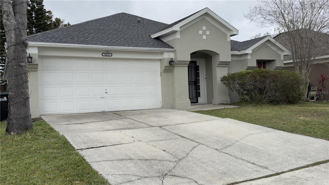 ranch-style home with an attached garage, concrete driveway, roof with shingles, stucco siding, and a front lawn