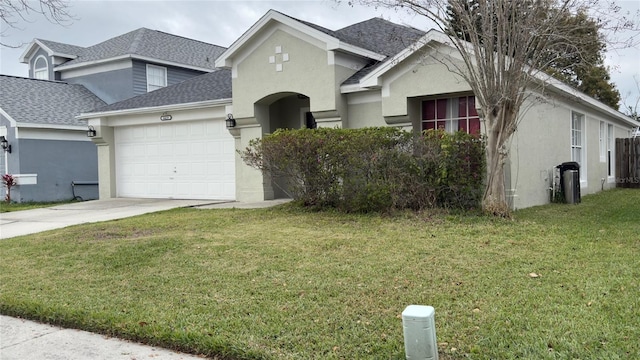 view of front of property featuring a garage, a front lawn, concrete driveway, and stucco siding