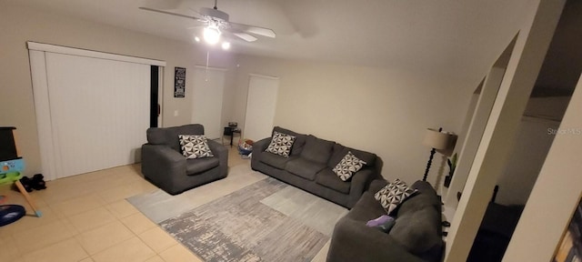 living area featuring tile patterned flooring and a ceiling fan