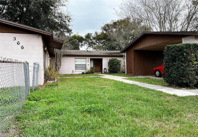 view of front of house with a front lawn and fence