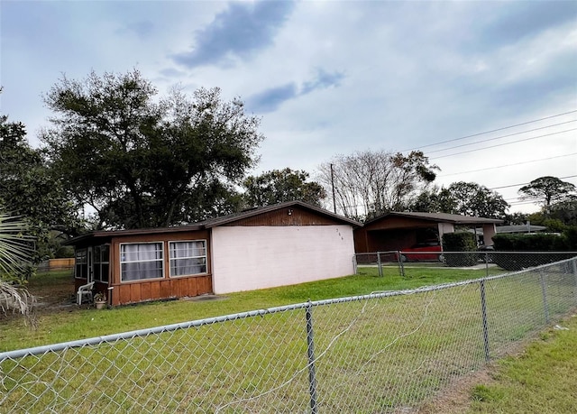 view of property exterior featuring fence and a lawn