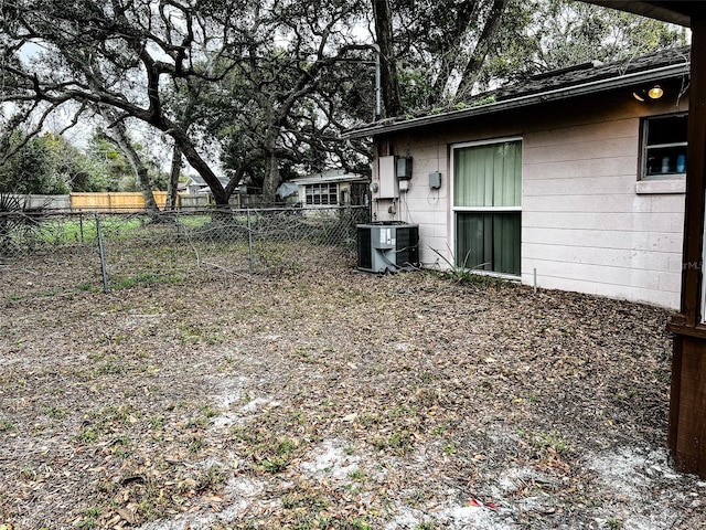 view of yard with cooling unit and fence