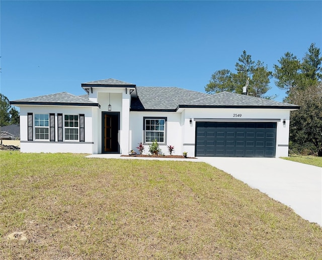 view of front of property featuring a garage, stucco siding, driveway, and a front yard