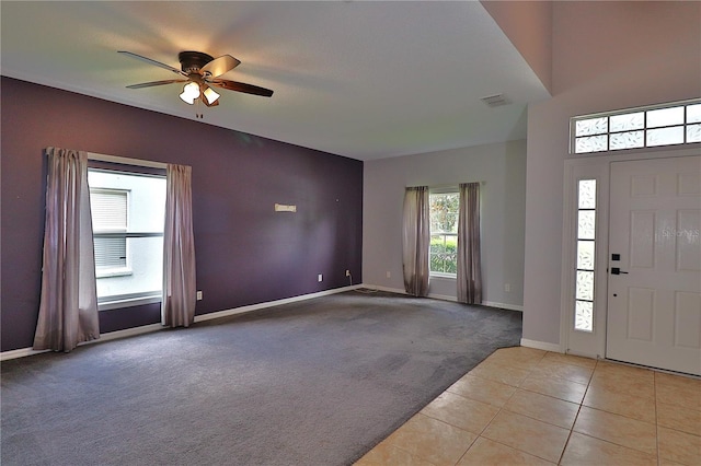 1862 Great Falls Way, Orlando, FL 32824 - entryway featuring light colored carpet, ceiling fan, and light tile patterned flooring