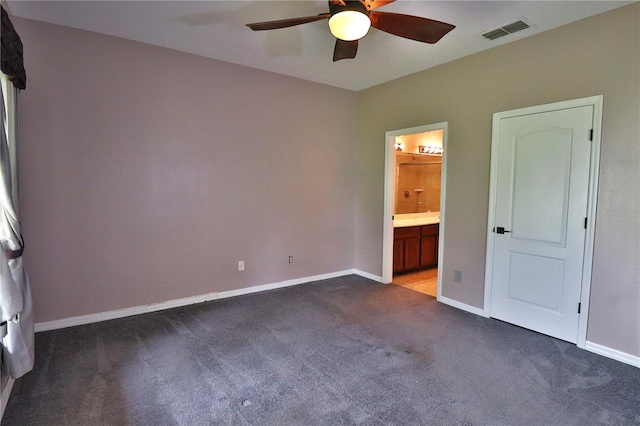 1862 Great Falls Way, Orlando, FL 32824 - unfurnished bedroom featuring dark carpet, ensuite bath, and ceiling fan