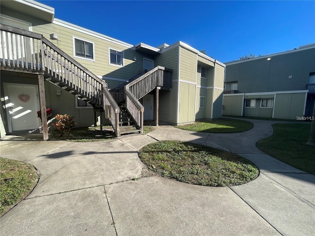 view of side of property featuring stairs