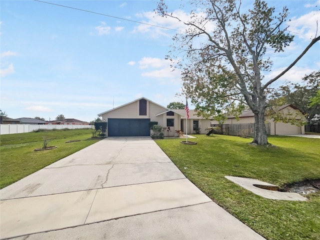 view of front of house with a front yard, driveway, an attached garage, and fence