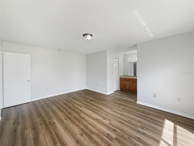 interior space with wood finished floors and baseboards