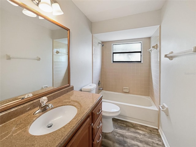 full bathroom featuring vanity, shower / washtub combination, wood finished floors, and toilet