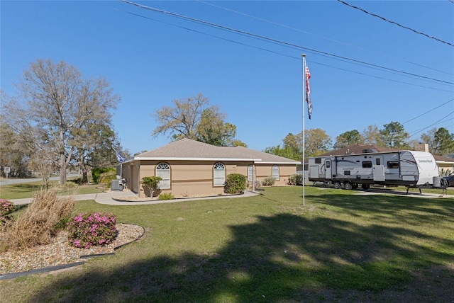 view of front of property featuring a front lawn and stucco siding