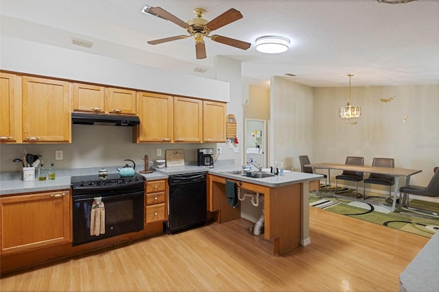 kitchen featuring under cabinet range hood, ceiling fan with notable chandelier, a peninsula, light wood-style floors, and black appliances